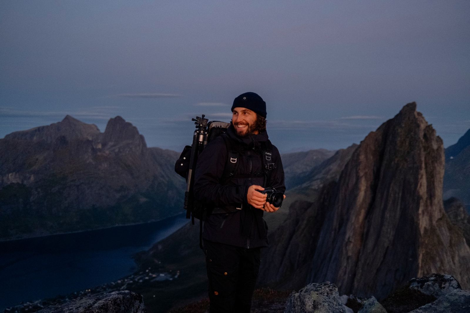 Ricardo smiling on a mountain top at blue hour