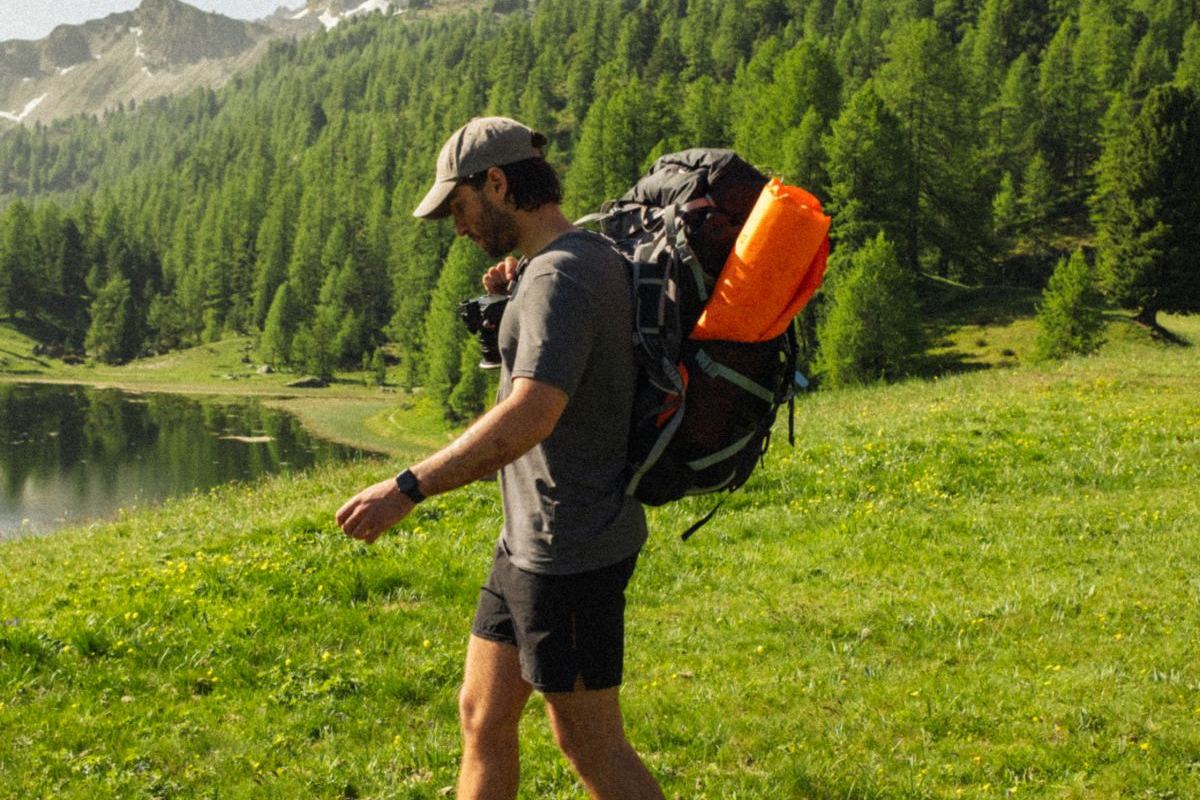 Ricardo hiking past a mountain lake