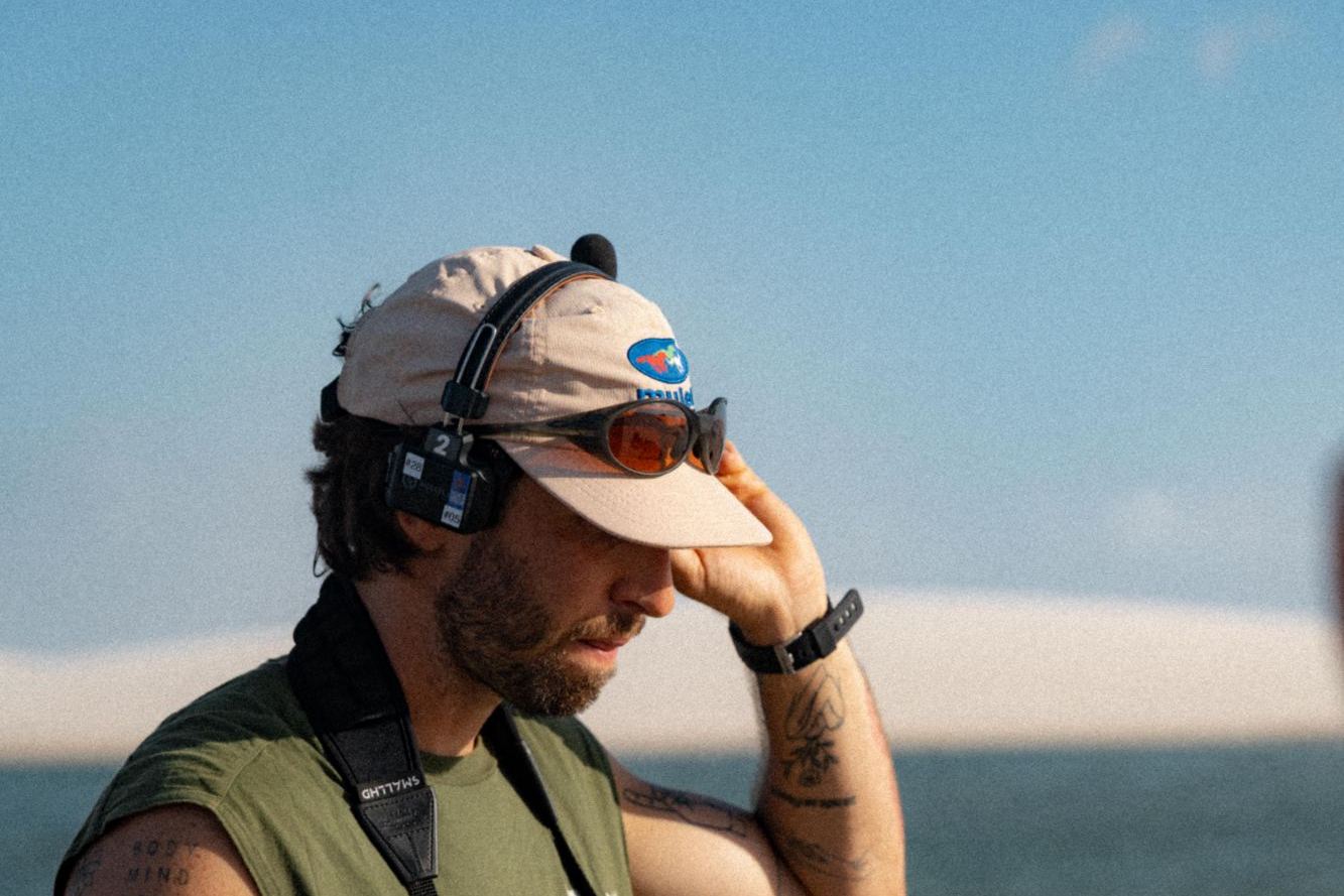 Ricardo with a monitor and headset on a shoot